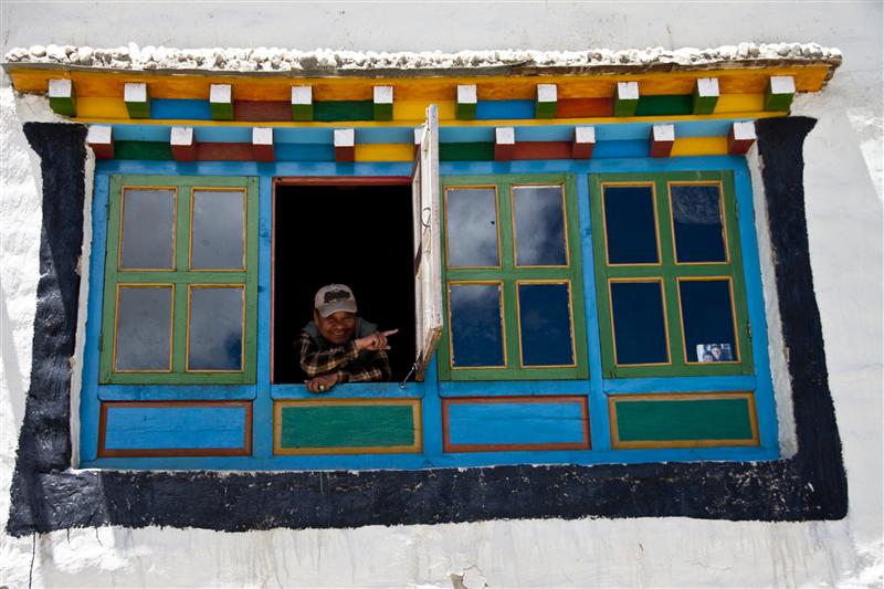 A local Loba women gives directions from my traditional styled window in Lo Manthang