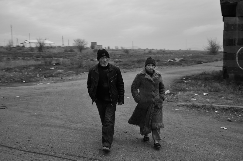 Couple walking to public transport in rural Armenia