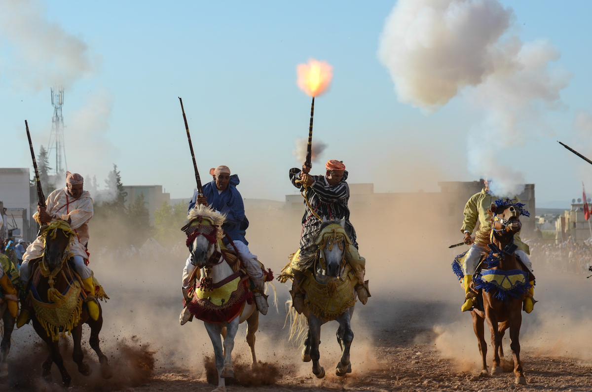 Fantasia - Riders grimace amongst  the gunpowder smoke and muzzle blasts