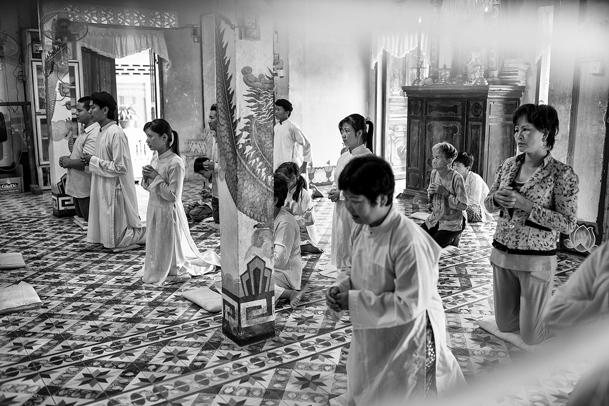 Devotees of the Cao Dai religion pray in their temple
