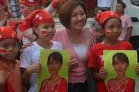 Young NLD supporters and their mother pose for a press photo on polling day in Rangoon