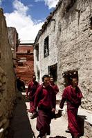 Young monks come out of the monastery for a break after prayers in Lo Mantang