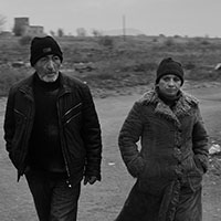 Couple walking to public transport in rural Armenia