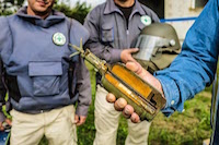 A defused fragmentation landmine is displayed in cross-section by a member of the Norwegian People's Aid